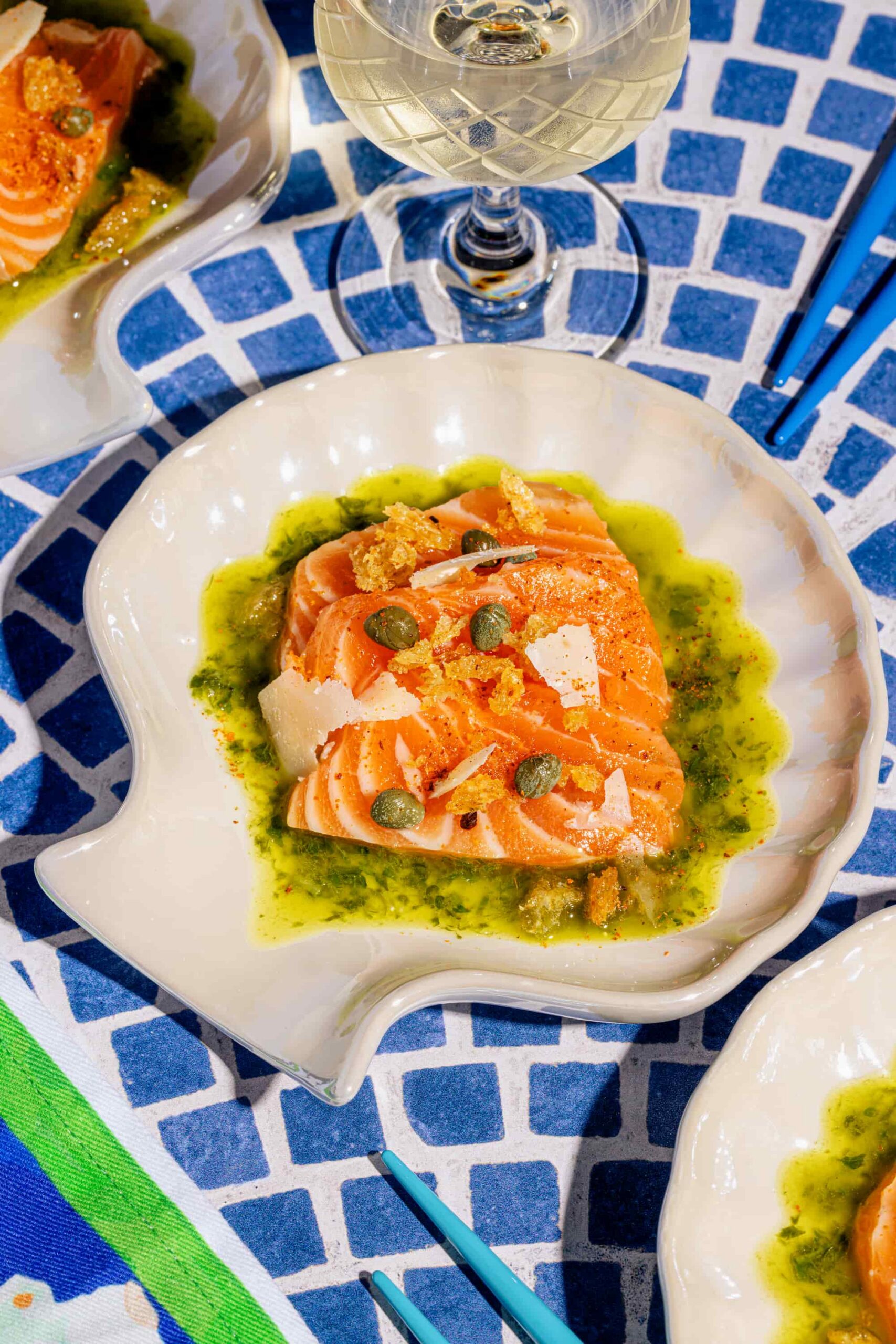 Petite assiette de bouchées de sashimi de saumon avec huile aux fines herbes