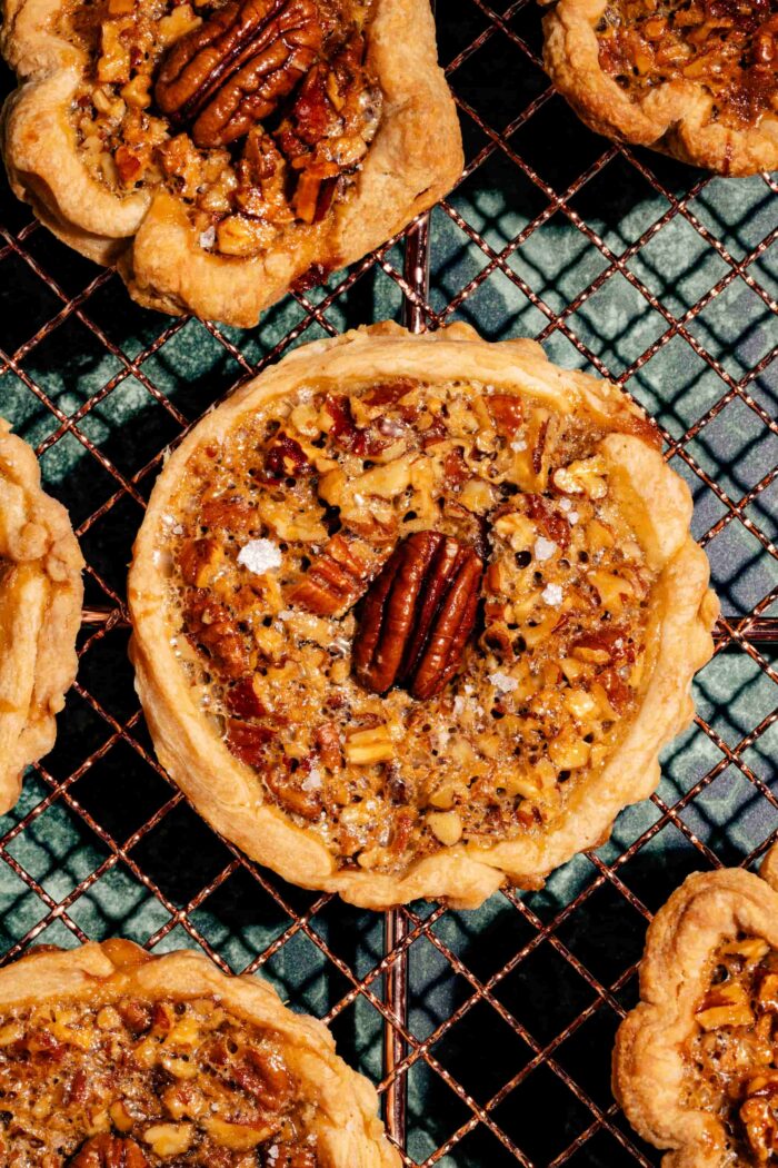 Tartelettes aux pacanes et caramel salé, garnies de noix croquantes et d'une garniture fondante dans une pâte dorée